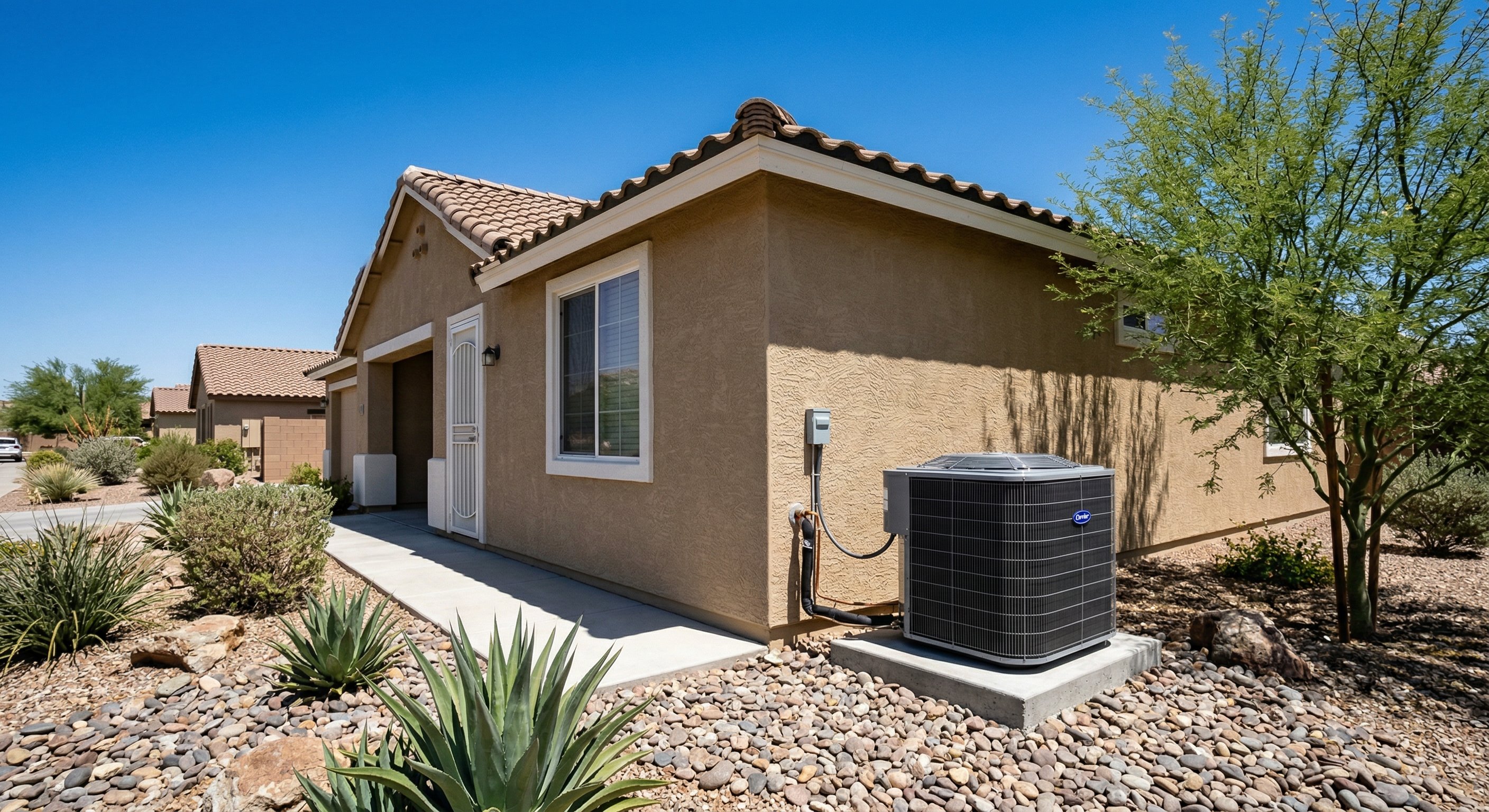 New AC unit installed on the side of a tan stucco home in Gilbert, AZ with desert landscaping