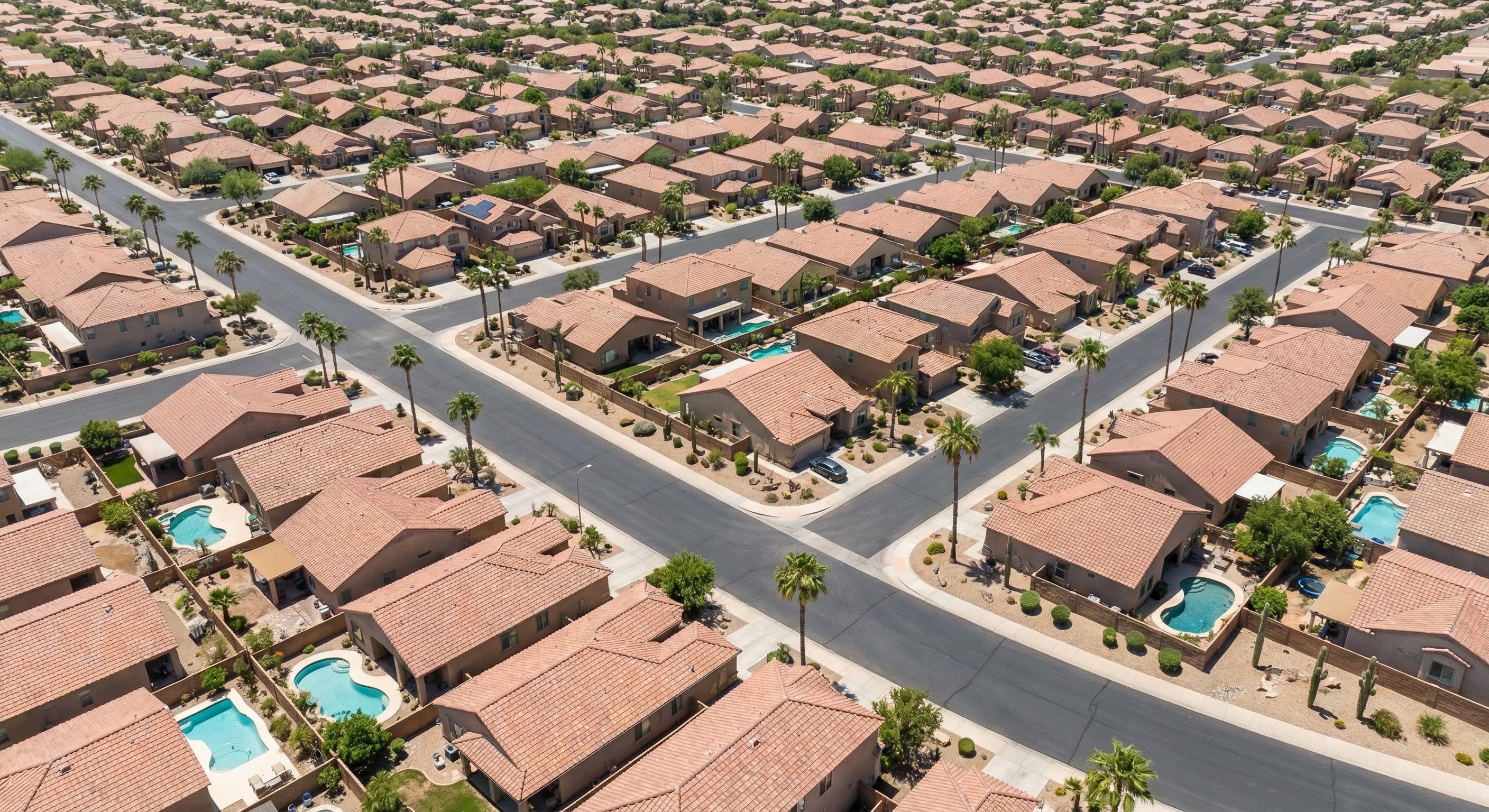 Aerial view of Phoenix metro subdivision with stucco homes and desert landscaping