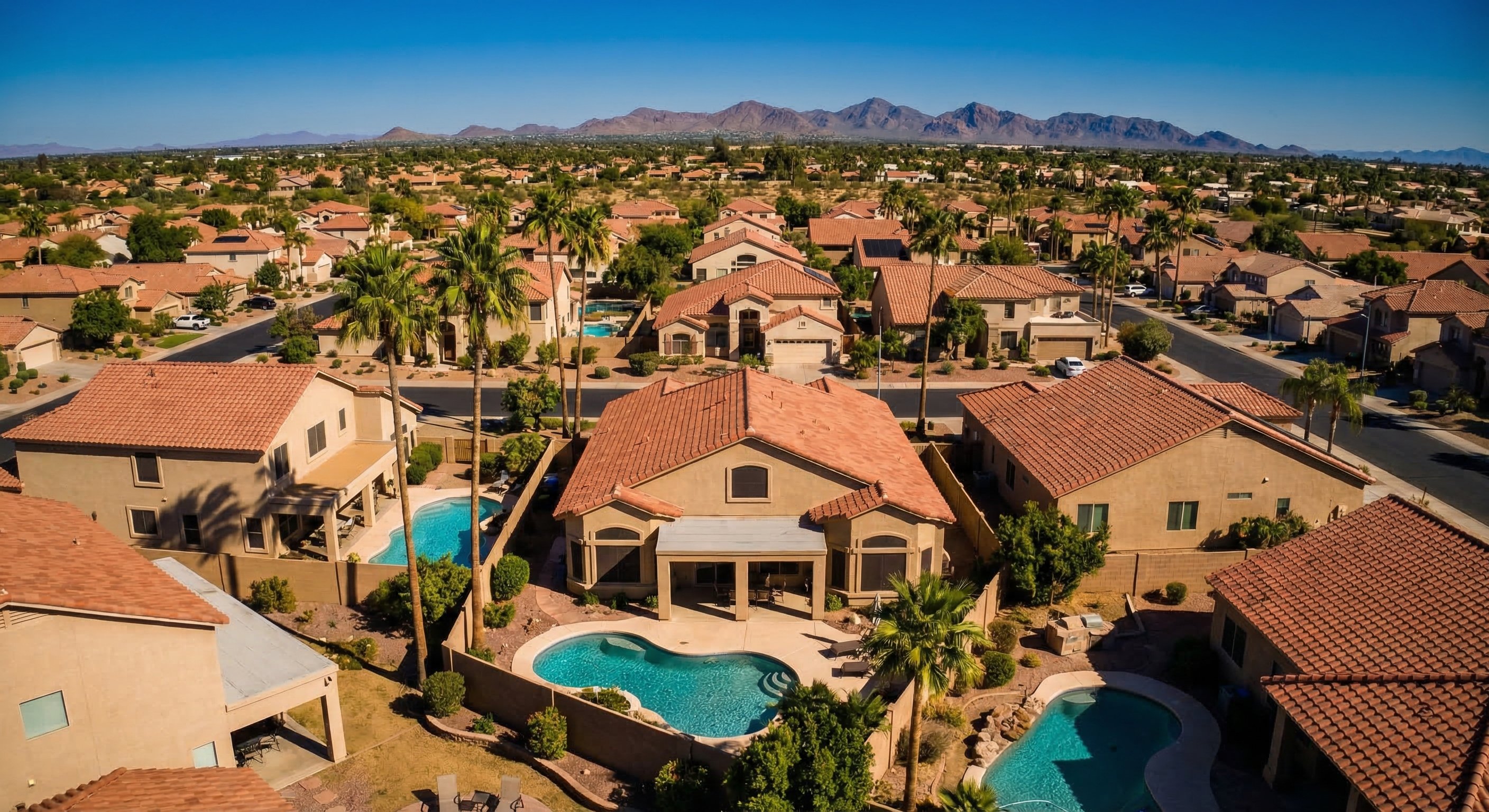 Aerial view of Phoenix suburban neighborhood with stucco homes and tile roofs
